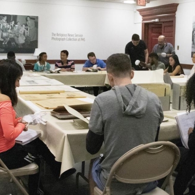 class in PHS meeting room looking at sources